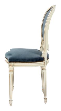 a white chair with blue upholstered seat and back cushion on the bottom side