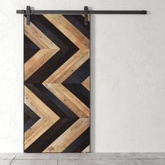 an open door with wooden planks on the side and black metal bars hanging from it