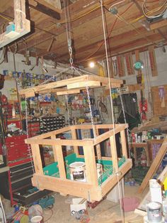 the inside of a garage with lots of tools hanging from it's ceiling and shelves