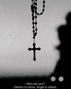 a black and white photo with a cross hanging from it's side