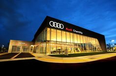 an audi dealership lit up at night