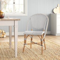 a chair sitting on top of a rug next to a table