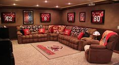 a living room filled with lots of couches and pillows on top of carpeted flooring