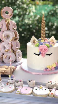 a table topped with cakes and donuts covered in frosting