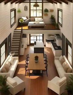 an open concept living room and dining area in a loft style home with wood flooring