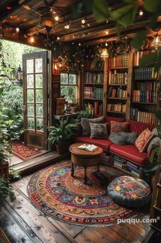 a living room filled with lots of furniture and bookshelves full of books on top of them