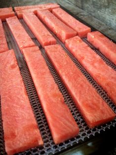 several slices of watermelon sitting on top of a metal grate