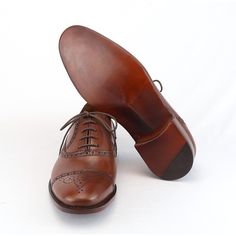 This lace-up shoe is a classic Oxford Half Brogue , elegant, current and differentiated, to be used with tailoring suits. The differentials of this Oxford are its perforations and perforations in the leather throughout its contour and its color, Mahogany, a woody brown tone that we handcraft exclusively here in our factory. The Mahogany color goes very well with suits in navy blue, light blue and graphite gray.   Made in Argentinean calfskin and 100% leather sole.  Exclusively made-to-order sho Mahogany Color, Brown Tone, Tassel Loafers, Tailored Suits, Lace Up Shoes, Blue Light, Loafer Shoes, Calf Skin, Casual Shoes