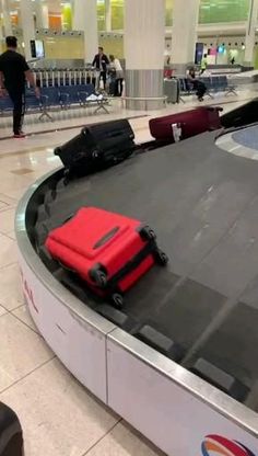 an airport baggage claim area with luggage on the conveyor belt