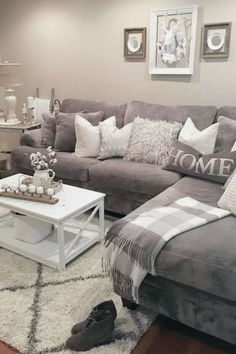 a living room filled with furniture and pillows on top of a white carpeted floor