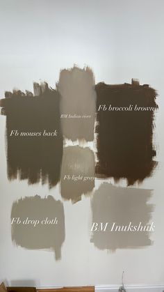 some brown and white paint samples on a wall