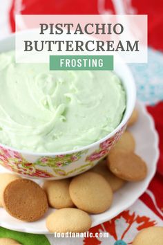 a white plate topped with cookies and a bowl filled with green frosted buttercream