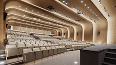 an empty auditorium with rows of chairs and a podium in front of the stage area