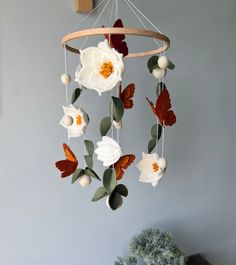 a mobile with flowers and leaves hanging from it