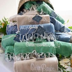 a pile of folded towels sitting next to each other on top of a white table