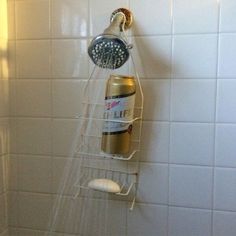 a shower head is attached to the side of a white tiled wall in a bathroom