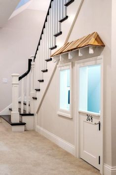 an open door leading to a staircase in a house with white walls and carpeting