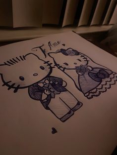 a drawing of two hello kitty characters on a piece of paper