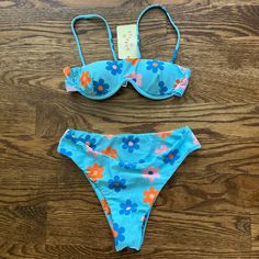 A Beautiful Bikini Set That Is Brand New! Has Adjustable Straps, Removable Padding, And Isn’t Too Cheeky. Retro Blue Swimwear For Spring, Retro Blue Swimwear For Summer, Retro Blue Swimwear For Swimming, Beachy Swimwear With Vibrant Print, Colorful Floral Print Beachwear Swimwear, Playful Floral Print Vacation Swimwear, Orange Floral Print Beachy Swimwear, Vibrant Blue Printed Swimwear, Bright Swimsuit