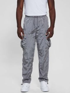 Nylon cargo pants Shiny crinkle construction Signature logo patch Dropped rise, sits at hips Relaxed fit and straight leg Dual slip pockets with side cargo pocketing Elastic drawstring waistband 15" leg opening Measurements taken from a size M 100% Polyamide/Nylon Nylon Cargo Pants, Drawstring Waistband, Signature Logo, Cargo Pants, Patch Logo, Active Wear, Straight Leg, Relaxed Fit, Mens Outfits