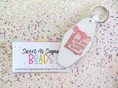 a keychain with a tag attached to it that says sweet as sugar beads