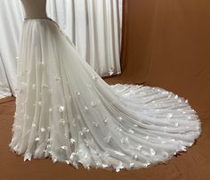 a white wedding dress on display in front of a window