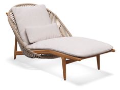 a wicker lounge chair with a cushion on it