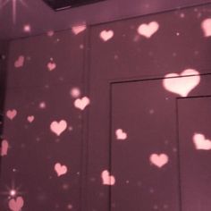 the light is shining on the wall with hearts