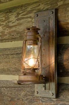 an old fashioned lantern hanging from the side of a wooden wall