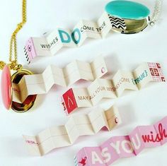 three different types of necklaces on a white surface with words written across the chain