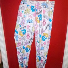 New W/O Price Tag Is An Overstock Outlet (Has Black Line Going Thru Cloth Label Name To Prevent Store Return) Authentic Care Bears Pants - Sleep/Lounge Pants - 95% Recycled Polyester, 5% Spandex - Elastic Ankles - Size Large (12/14) ; Measures Approx. 33" Elastic Waist, 38" Length Cute Cotton Lounging Pants, Cute Stretch White Pants, White Stretch Pants For Sleep, Cute Loungewear Pants With Elastic Waistband, Cute White Pants For Sleepover, White Bottoms With Elastic Waistband For Bedtime, Cute Lounging Bottoms, White Pants For Sleep In Spring, Casual White Sleep Pants