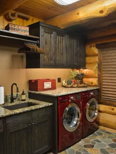 a washer and dryer in a room with wooden walls, flooring and cabinets