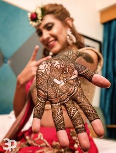 a woman is showing off her henna