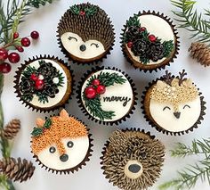 cupcakes decorated as hedgehogs, fox and deer faces with pine cones