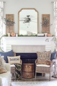 a living room filled with furniture and a fire place under a mirror on top of a mantle