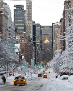 a taxi cab driving down a snow covered street