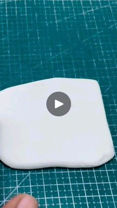 a video demonstrating how to use an object on a cutting mat with scissors and tape