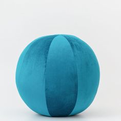 a blue ball sitting on top of a white floor