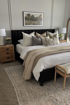 a bedroom with a large bed, dresser and mirror in the corner next to it