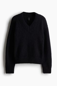 Loose-fit sweater in a soft knit. V-neck  dropped shoulders  and long sleeves. Ribbing at neck  cuffs  and hem.