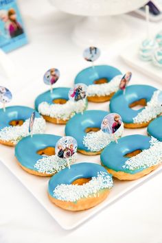 there are many donuts with frosting and decorations on the top one is blue