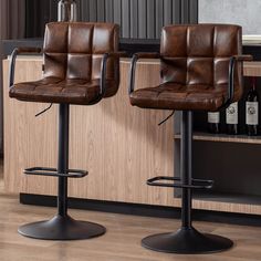 two brown leather bar stools in front of a counter