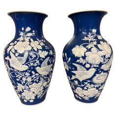 two blue and white vases sitting next to each other