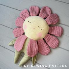 a pink flower shaped stuffed animal hanging from the side of a white wooden wall with text overlay that says, free sewing pattern