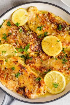 chicken with lemons and parsley in a skillet