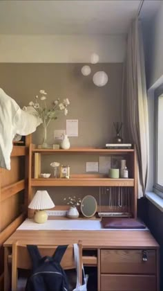 a bedroom with a bed, desk and shelves on the wall next to a window