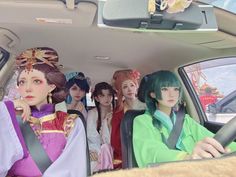 a group of women sitting in the back seat of a car