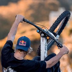 a man is holding up his bike with both hands