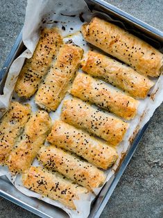 bread rolls with sesame seeds in a baking pan