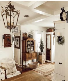 a living room filled with furniture and a clock on the wall above it's doorway